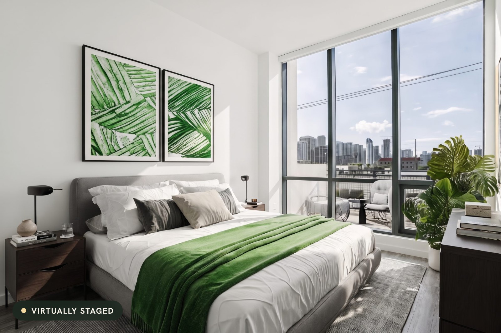 A bedroom with floor-to-ceiling windows, virtually staged with a gray bed, a green throw and leaf prints, labeled "Virtually staged"