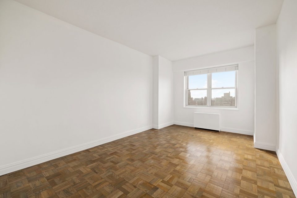 Empty bedroom before virtual staging, with parquet floors