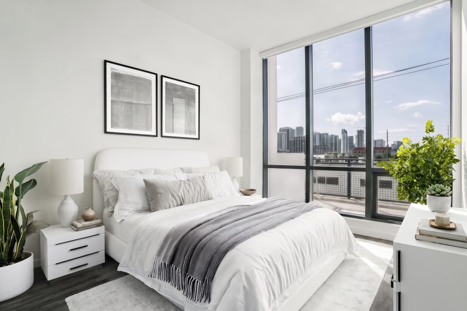 Bedroom virtually staged by TINTY in Minimalist style with taupe accents, with a city skyline view